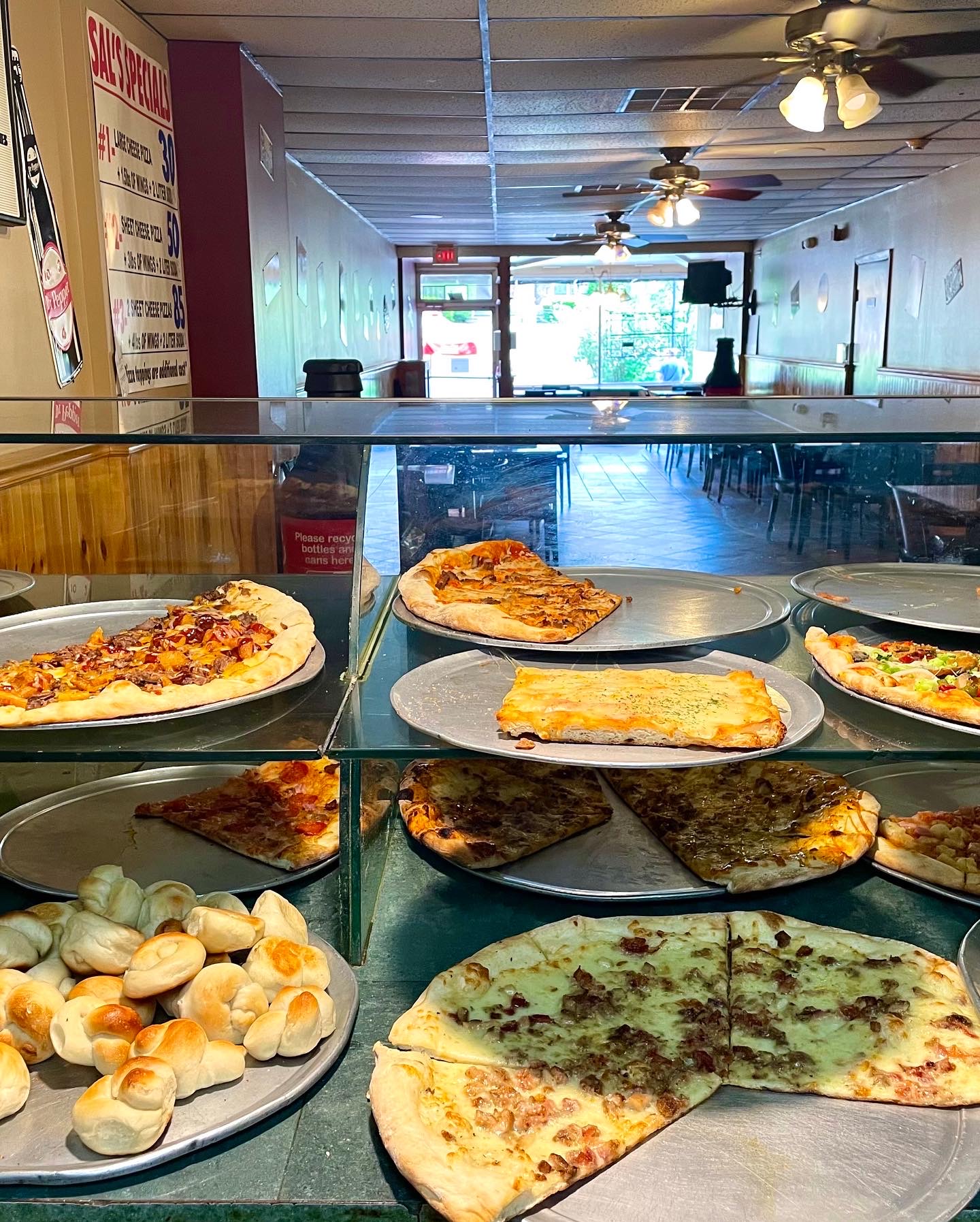 Pizza slices and garlic knots on display