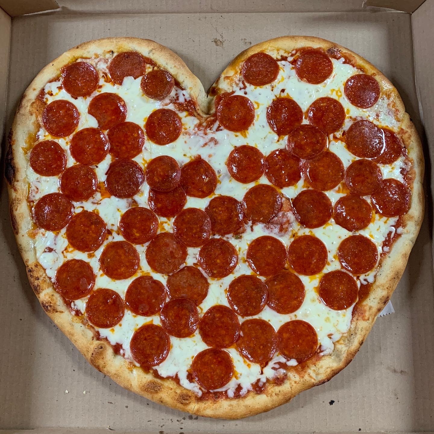 Heart-shaped pepperoni pizza for special occasions