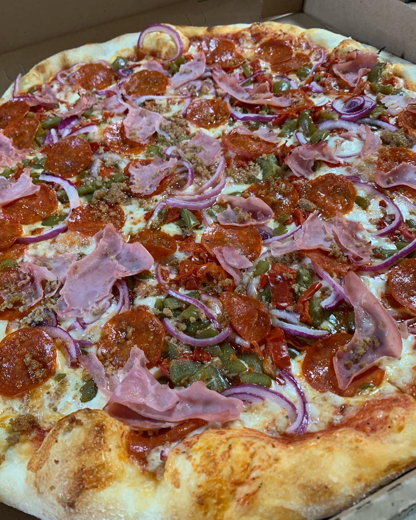 Sal's Supreme Pizza with pepperoni, ham, onions, and peppers